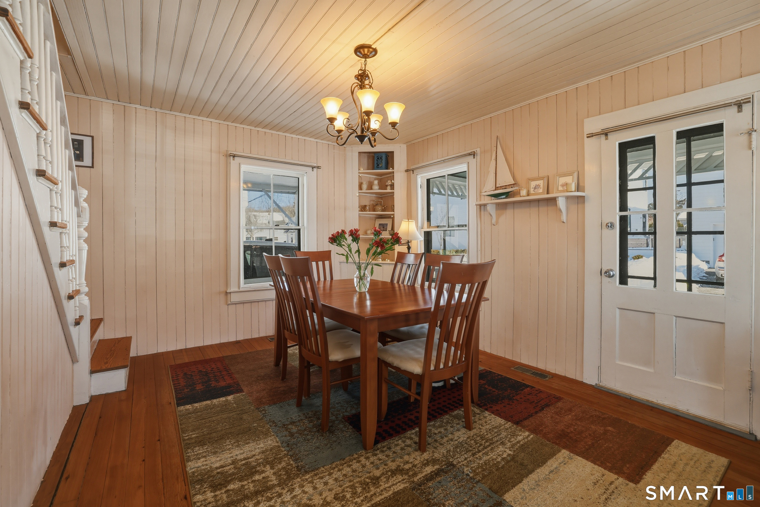11 Tuxis Road Madison, CT 06443 - Photo 7 of 40 Charming dining room with built-in curio, complemented by wood floors and beadboard detailing throughout the home.