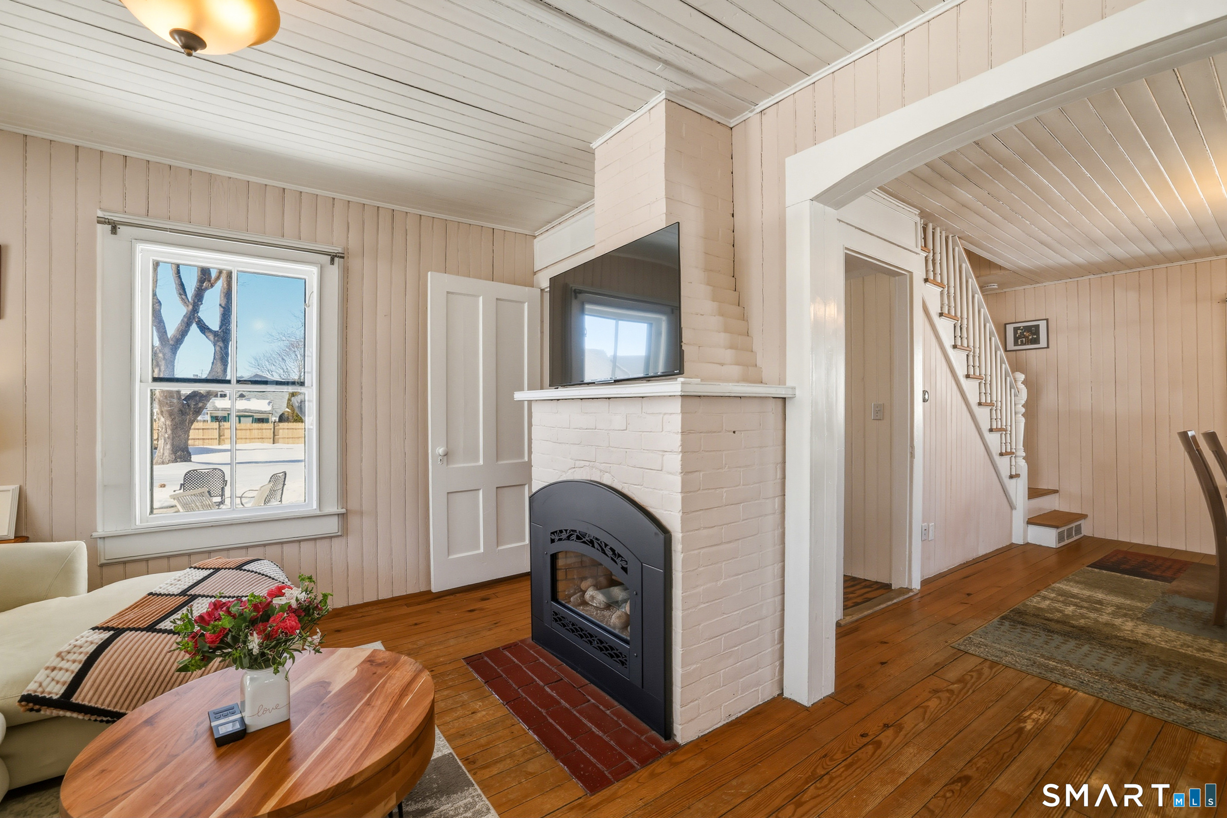 11 Tuxis Road Madison, CT 06443 - Photo 10 of 40 Enjoy cozy nights by the living room's natural gas fireplace, thermostat-controlled to comfortably heat up to 1,200 SF.