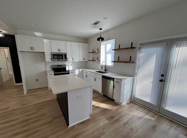 143 Addie Jane Lane Buchanan, GA 30113 - Photo 11 of 31 a kitchen with stainless steel appliances a sink a stove a refrigerator cabinets and a wooden floor