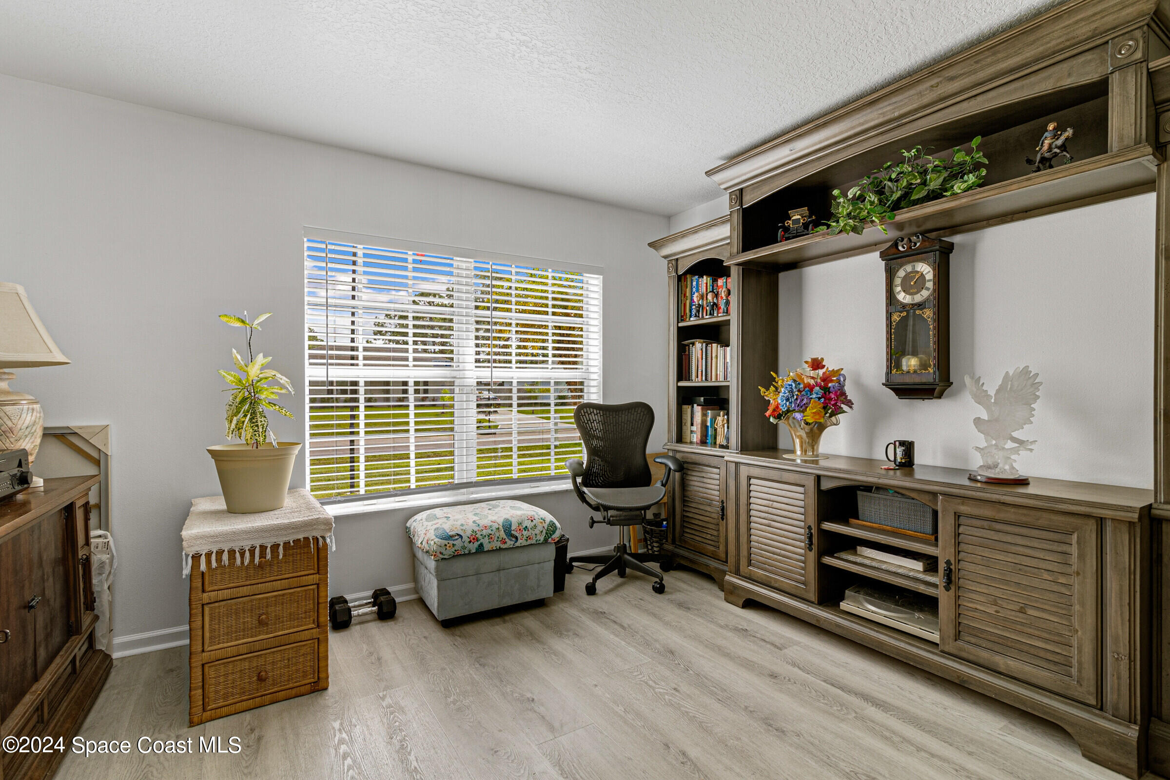 931 Pandora Road Southeast Palm Bay, FL 32909 - Photo 18 of 34 a bedroom with furniture and a window