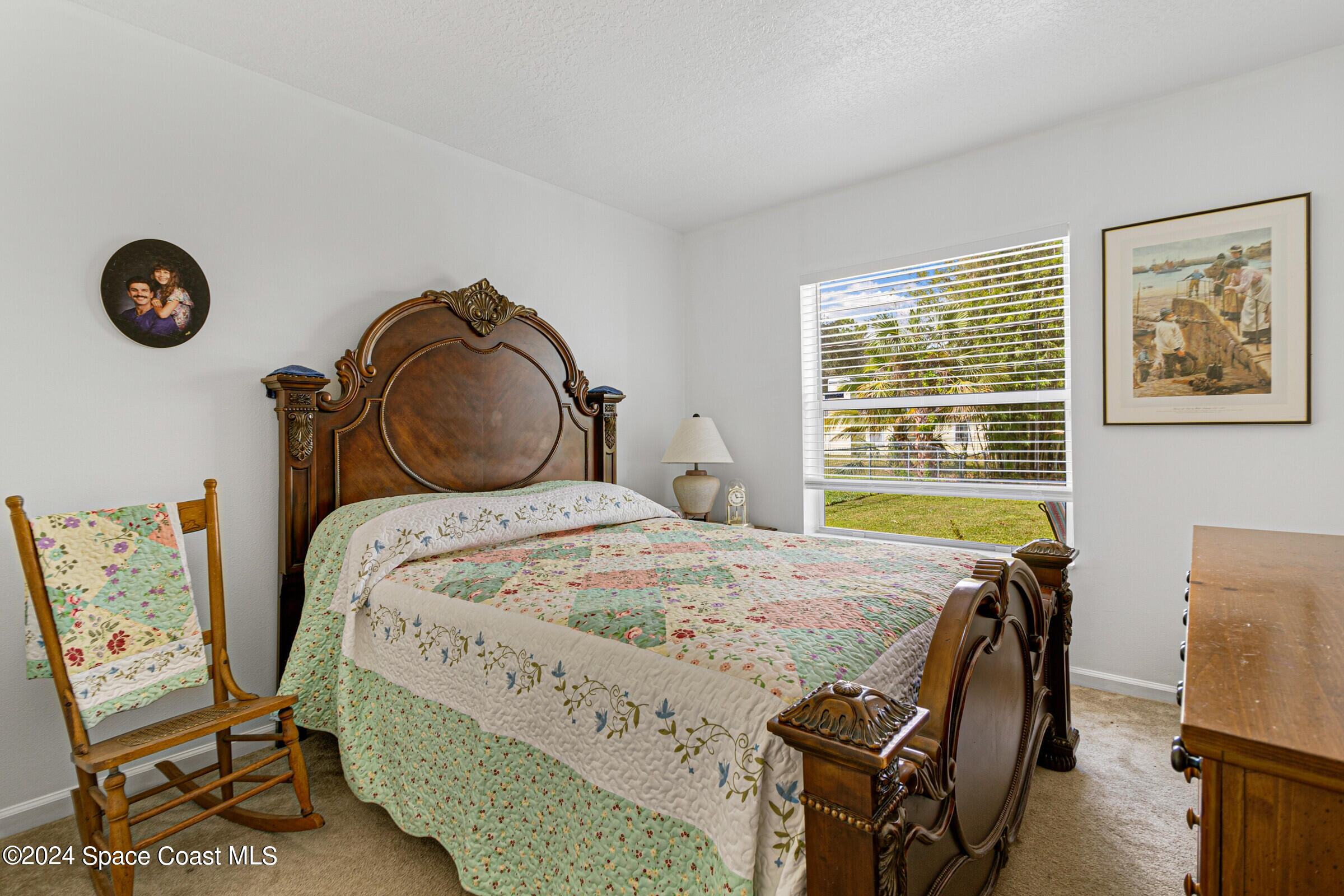 931 Pandora Road Southeast Palm Bay, FL 32909 - Photo 23 of 34 a bedroom with a bed and a table with chair