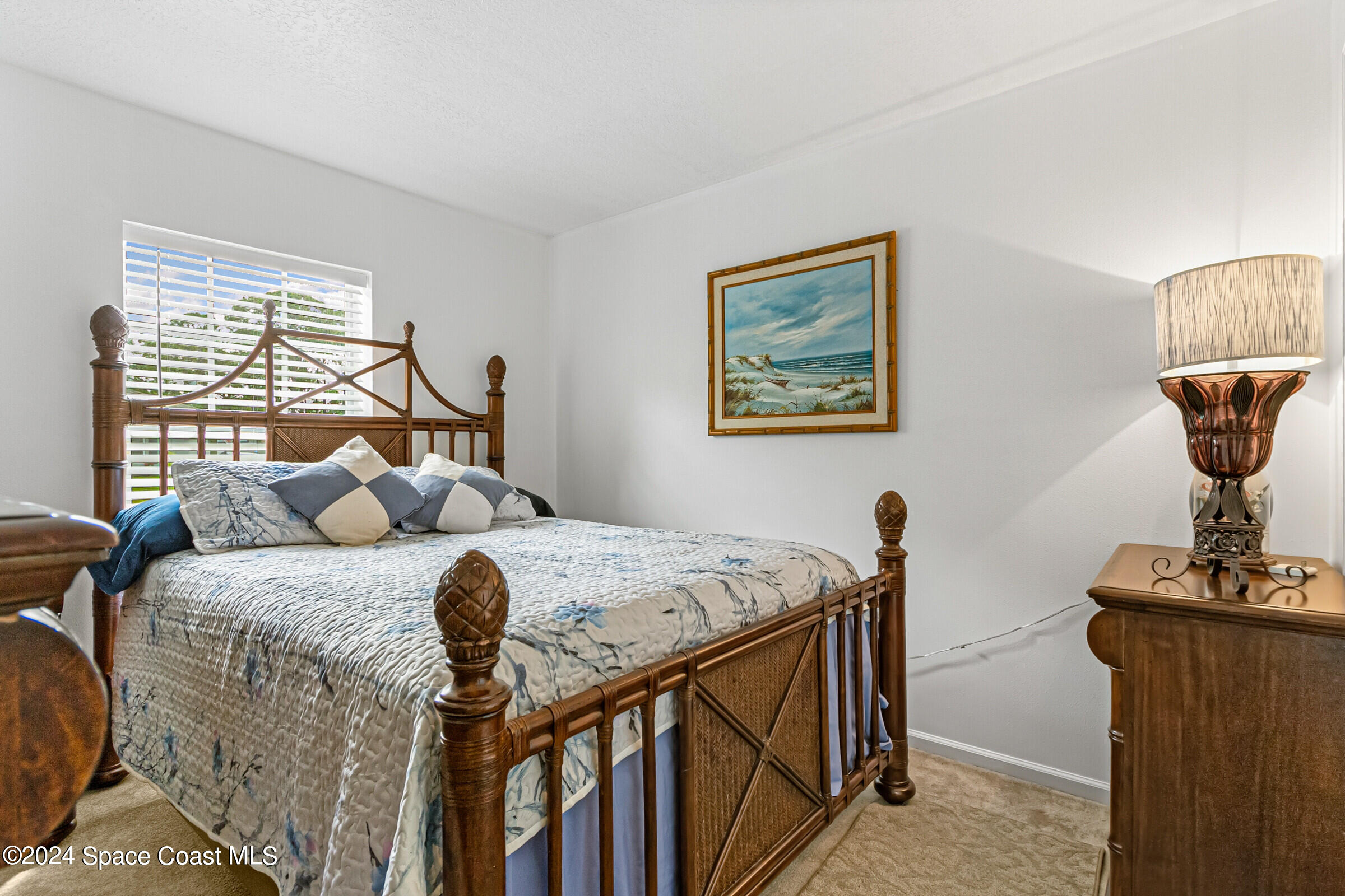 931 Pandora Road Southeast Palm Bay, FL 32909 - Photo 24 of 34 a bedroom with a bed and wooden floor