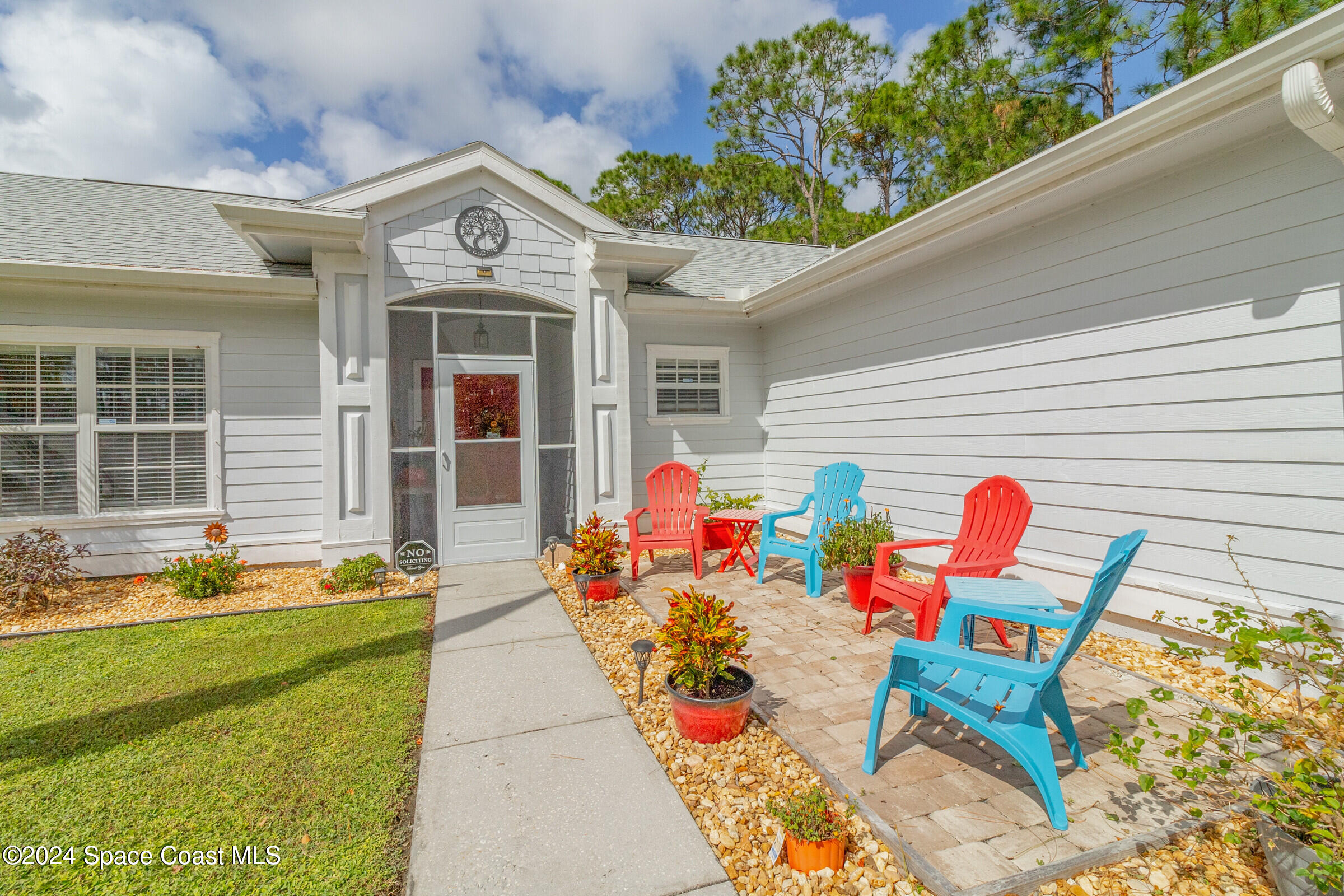 931 Pandora Road Southeast Palm Bay, FL 32909 - Photo 33 of 34 a front view of a house with outdoor seating