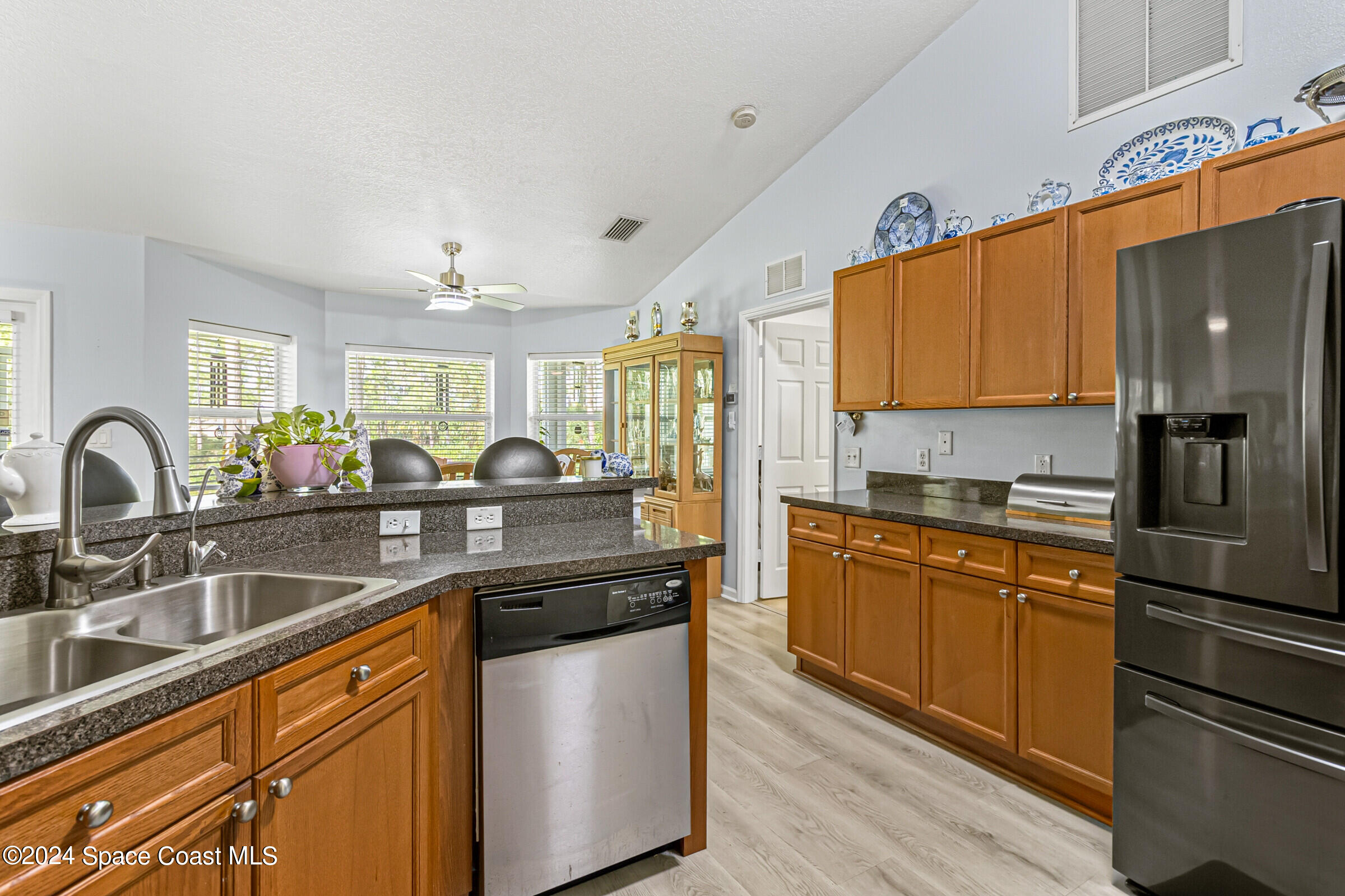 931 Pandora Road Southeast Palm Bay, FL 32909 - Photo 5 of 34 a kitchen with stainless steel appliances granite countertop a sink a stove and refrigerator