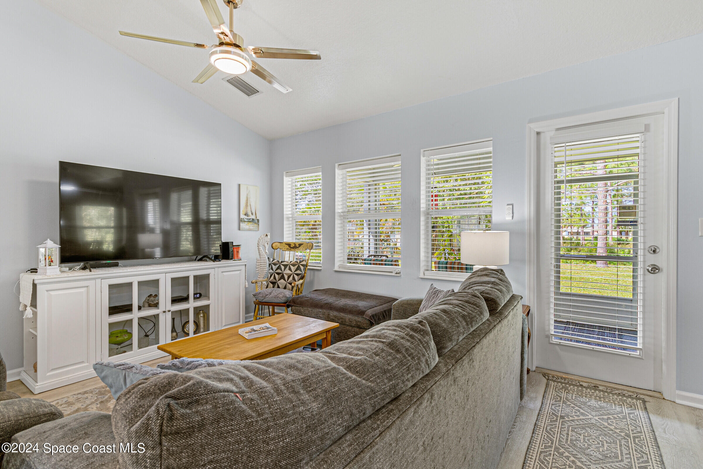 931 Pandora Road Southeast Palm Bay, FL 32909 - Photo 10 of 34 a bedroom with a bed and a flat screen tv