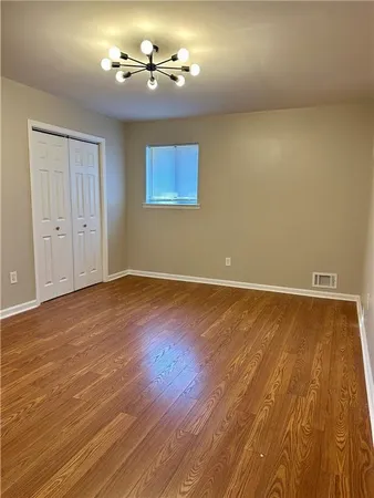 a view of room with wooden floor