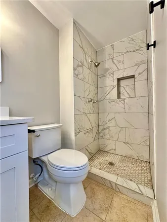 a bathroom with a toilet and a shower
