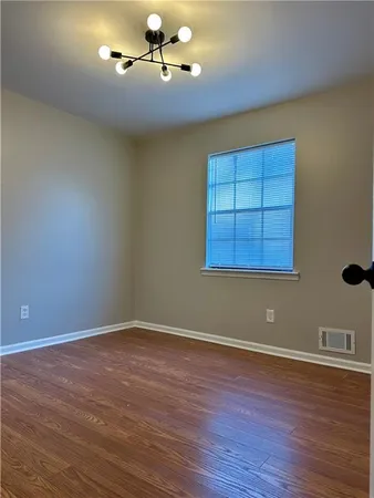 a view of a room with wooden floor and fan