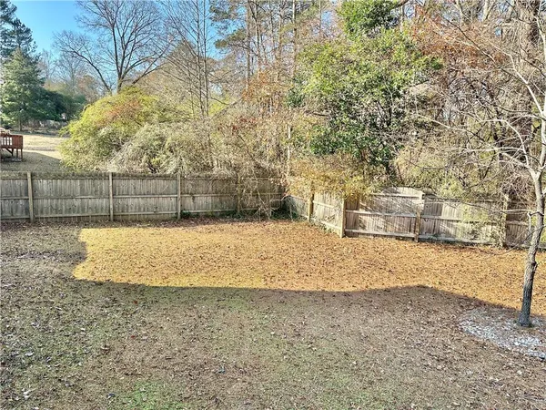 a view of a yard with large trees