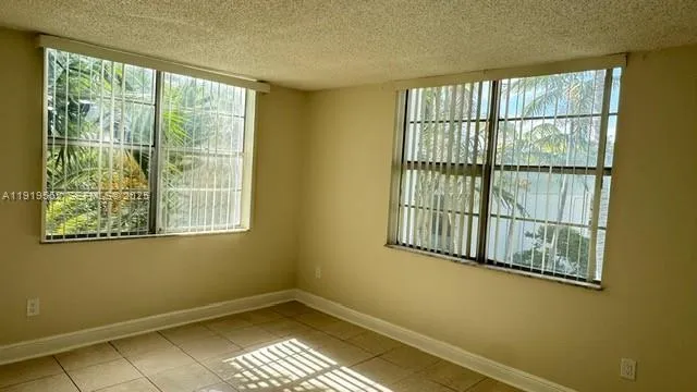 an empty room with closet and entrance
