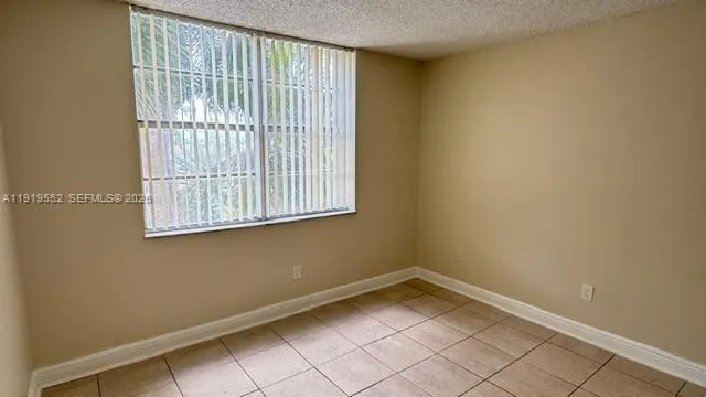 a bathroom with a granite countertop toilet sink and mirror