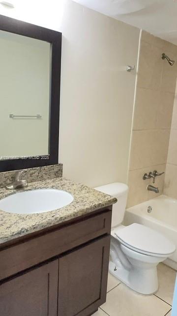 486 Northwest 165th Street, Unit B302 Miami, FL 33169 - Photo 32 of 34 a bathroom with a granite countertop toilet sink and mirror