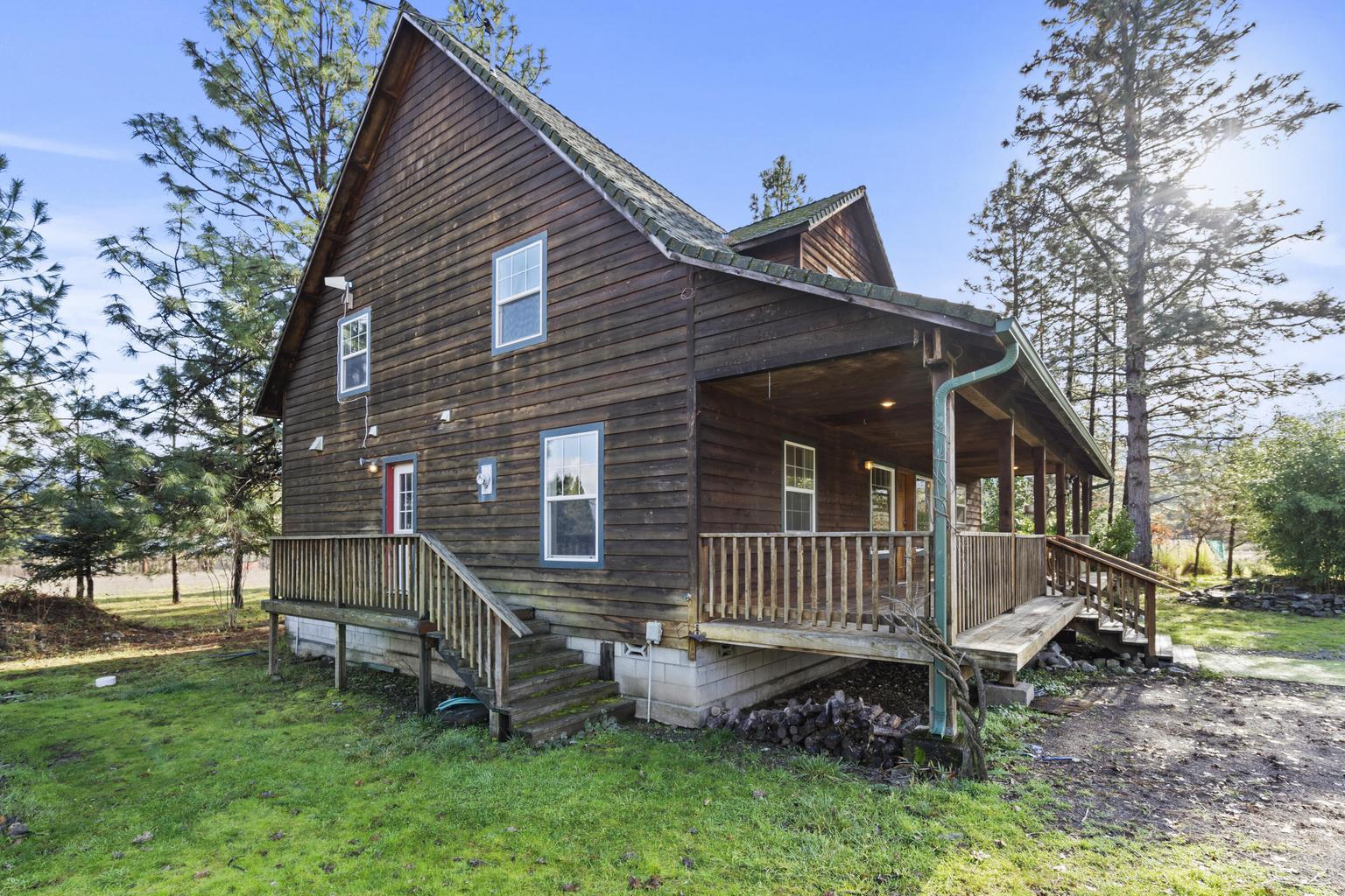 1190 Cedar Flat Road Williams, OR 97544 - Photo 3 of 45 a front view of a house with a garden and deck