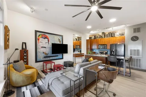 a living room filled with furniture and a chandelier
