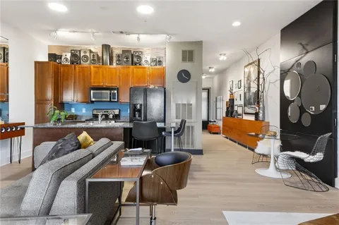 a living room with furniture and kitchen view
