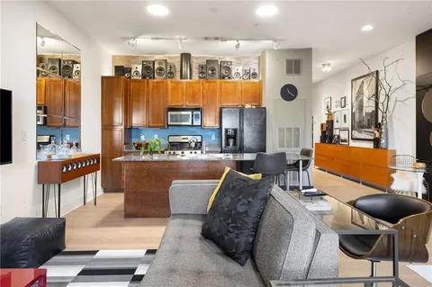 a view of a livingroom with furniture and a flat screen tv