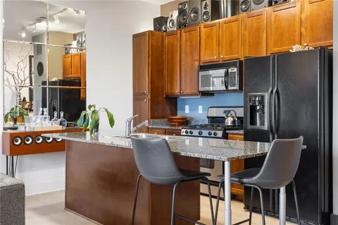 a kitchen with sink refrigerator and cabinets