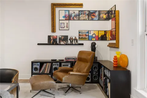 a bedroom with a bed and a mirror on the dresser
