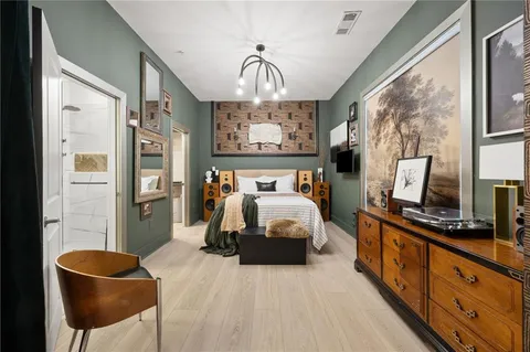 a bedroom with a bed a flat screen tv and balcony