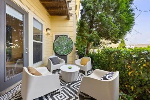 a view of a house with backyard and sitting area