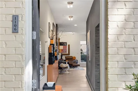 a hallway with a view of living room with furniture