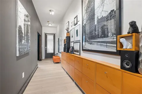 a living room with furniture kitchen view and a flat screen tv
