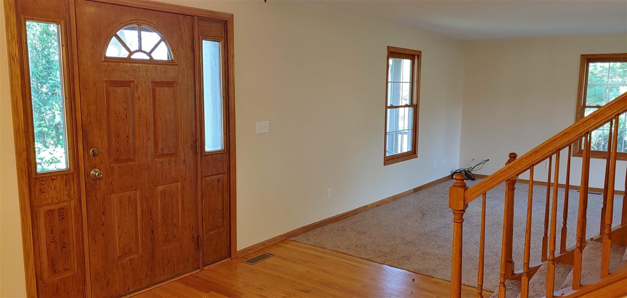 20979 Free Church Road Caledonia, IL 61011 - Photo 11 of 40 an entryway with wooden floor and stairs
