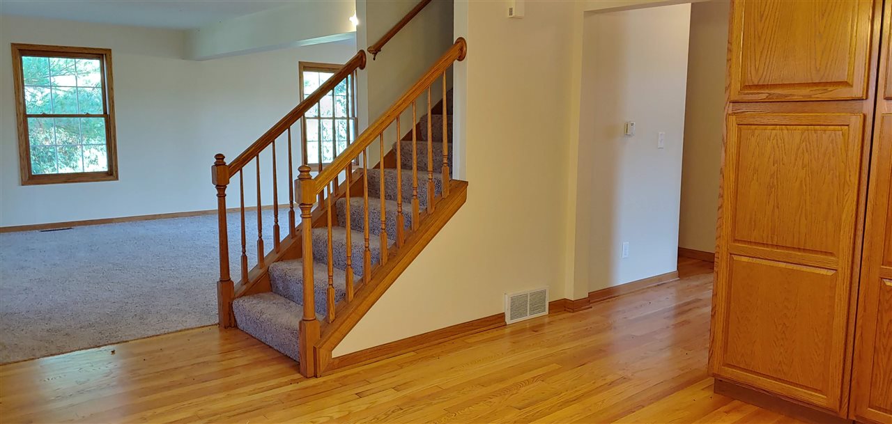20979 Free Church Road Caledonia, IL 61011 - Photo 14 of 40 a view of front door with wooden floor and stairs