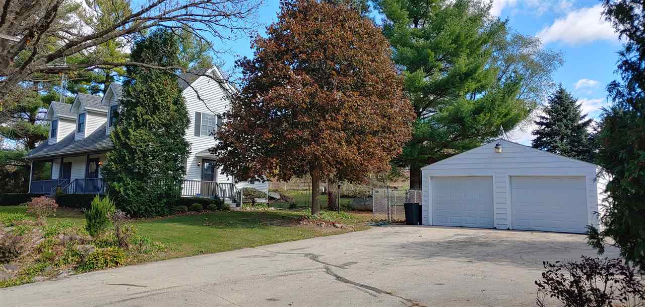 20979 Free Church Road Caledonia, IL 61011 - Photo 2 of 40 a front view of a house with a yard and garage