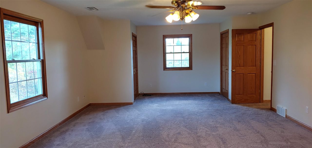 20979 Free Church Road Caledonia, IL 61011 - Photo 29 of 40 an empty room with windows and chandelier fan