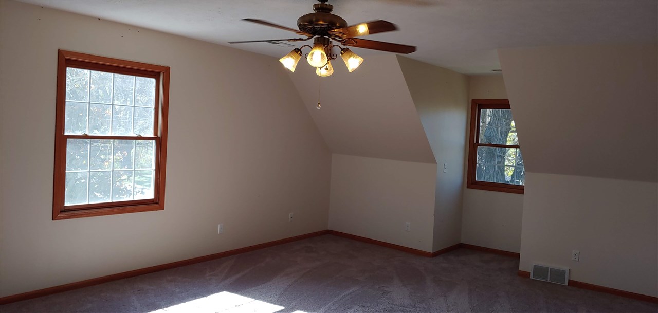 20979 Free Church Road Caledonia, IL 61011 - Photo 30 of 40 an empty room with windows and fan