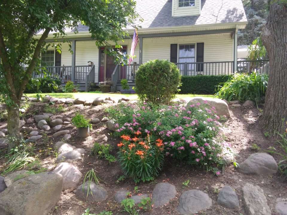 20979 Free Church Road Caledonia, IL 61011 - Photo 33 of 40 a front view of a house with a yard and a garden