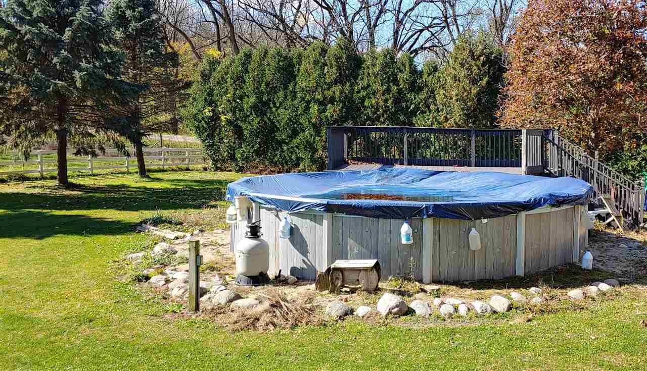 20979 Free Church Road Caledonia, IL 61011 - Photo 37 of 40 a front view of a house with a yard table and chairs