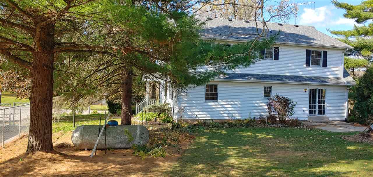 20979 Free Church Road Caledonia, IL 61011 - Photo 7 of 40 a view of a house with backyard and a tree
