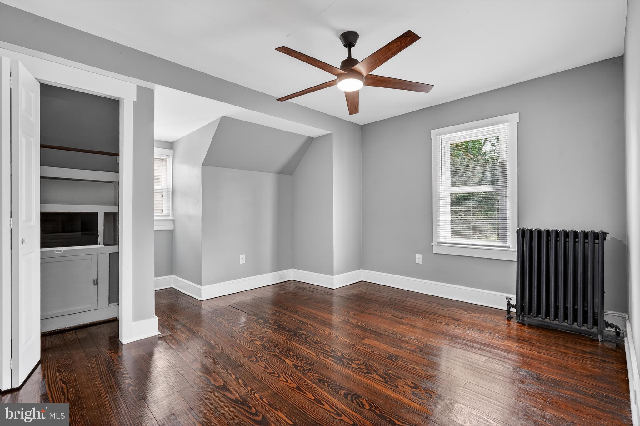 223 Noreg Place Brooklawn, NJ 08030 - Photo 23 of 36 an empty room with wooden floor and windows