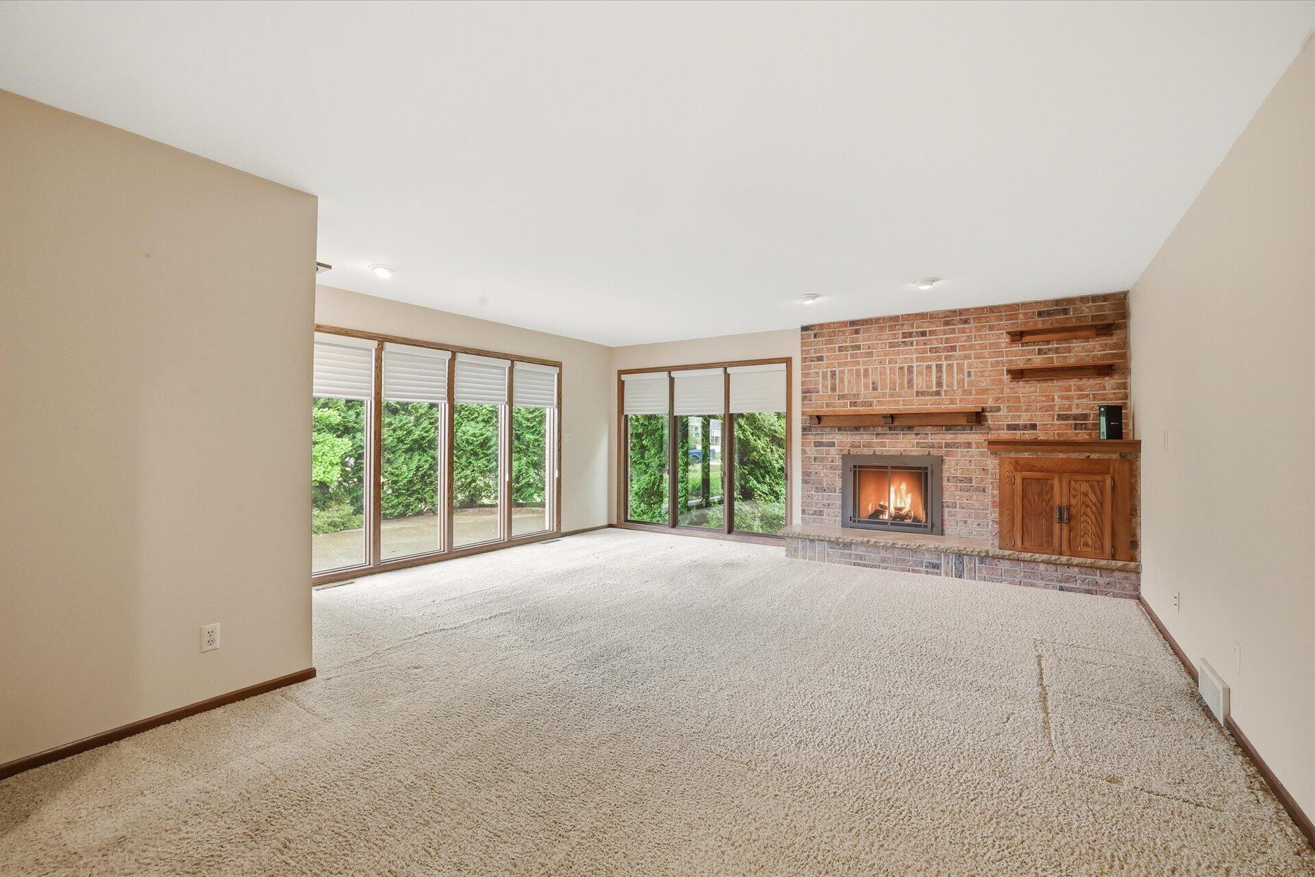 4100 South 119th Street Greenfield, WI 53228 - Photo 20 of 31 Family room is spacious with floor to ceiling windows and three year old gas insert!