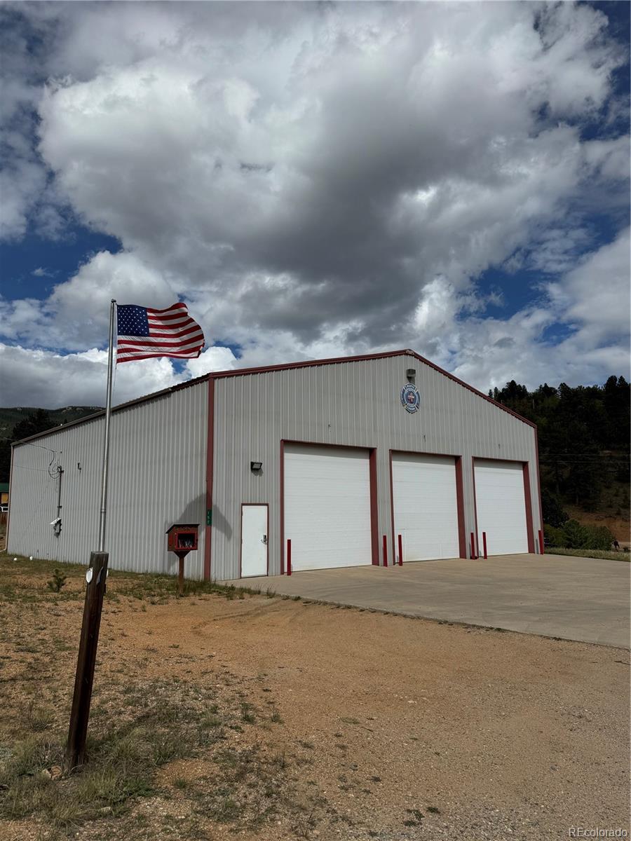 414 Hall Road Bailey, CO 80421 - Photo 4 of 19 a front view of a house with a garage