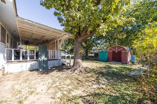 a view of a house with a yard and tree s