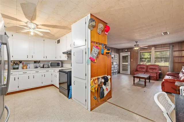 a kitchen with cabinets appliances a sink and a counter top space