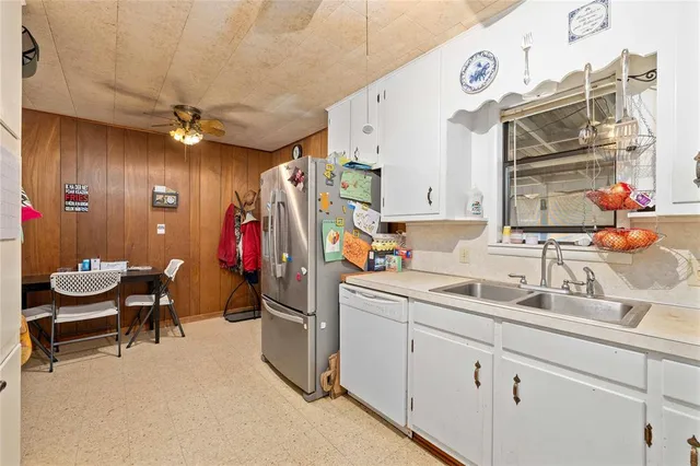 a bedroom with a bed and a dresser next to a window