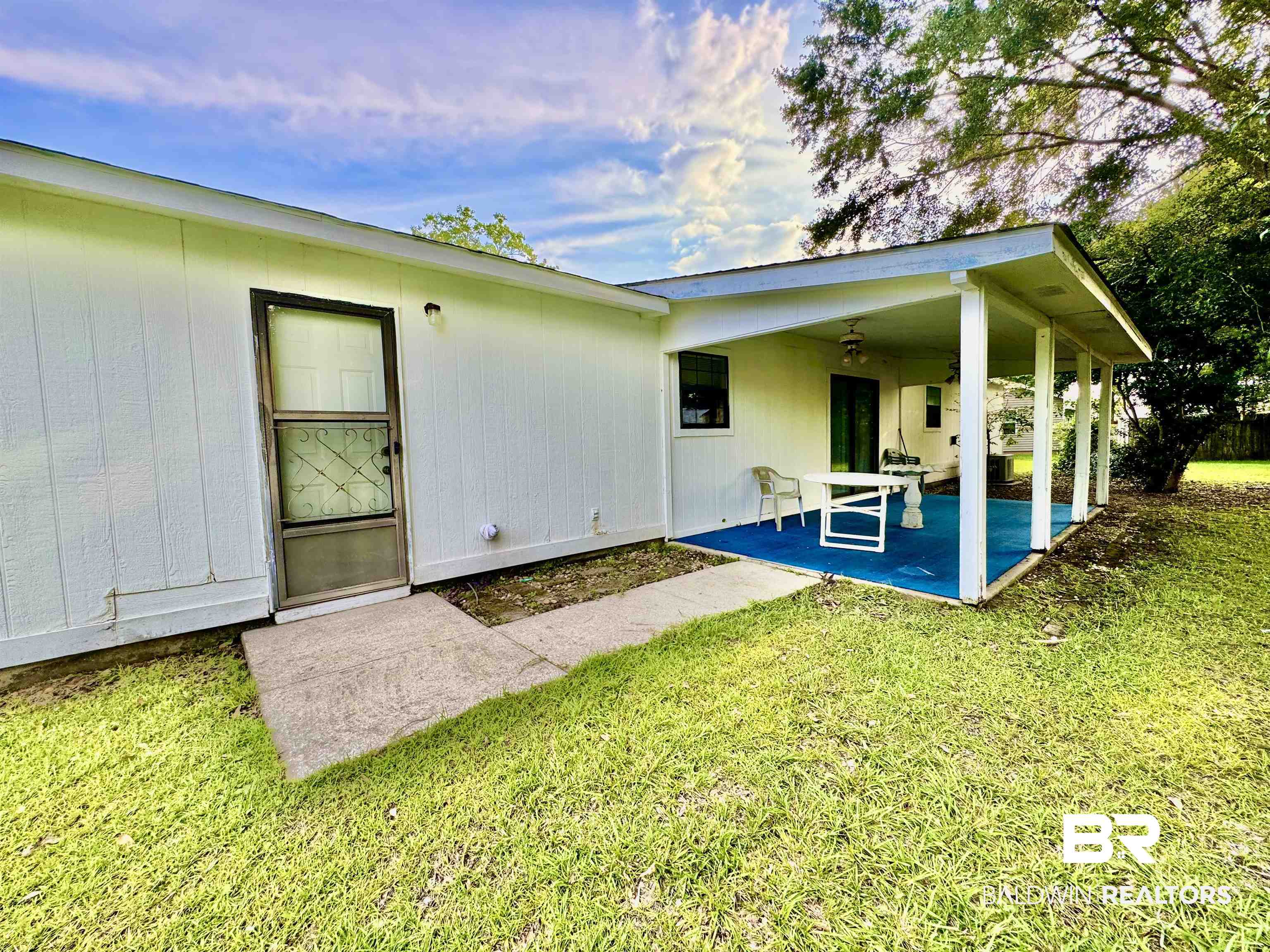 512 Deborah Court Foley, AL 36535 - Photo 2 of 23 Back of house featuring a patio, a lawn, and ceiling fan