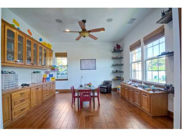2461 Lapis Road Carlsbad, CA 92009 - Photo 13 of 25 This large multi-use room is downstairs just off the front entry & features quality built-in cabinetry that could serve for a great playroom, home office, or teen lounge. ** NEW hardwood just installed!