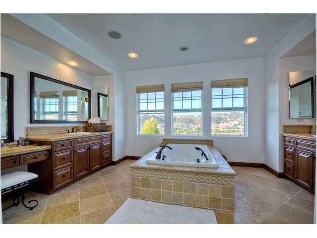 2461 Lapis Road Carlsbad, CA 92009 - Photo 15 of 25 Spa-inspired tones and designer finishes. This master bath also has a large dual-head shower enclosure that is also wrapped in tumbled travertine.