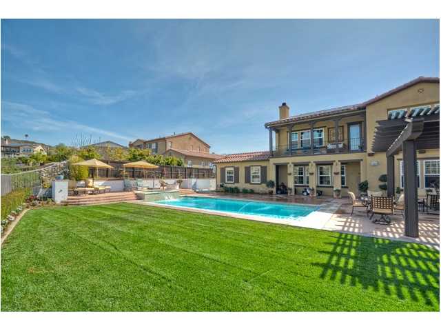 2461 Lapis Road Carlsbad, CA 92009 - Photo 4 of 25 Not often are backyards large enough to accommodate a large pool as well as space for a volleyball court, soccer practice and outside dining ** Sunny, private and grassy yard on an all usable and spacious 12,564 sf lot