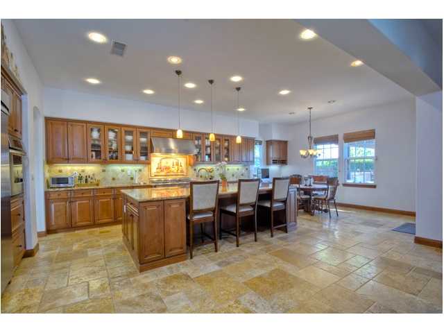 2461 Lapis Road Carlsbad, CA 92009 - Photo 7 of 25 HEART OF THE HOME ... Gorgeous travertine flooring surrounds this spacious and well-appointed Kitchen. The large center island offers additional seating, storage and space for entertaining.