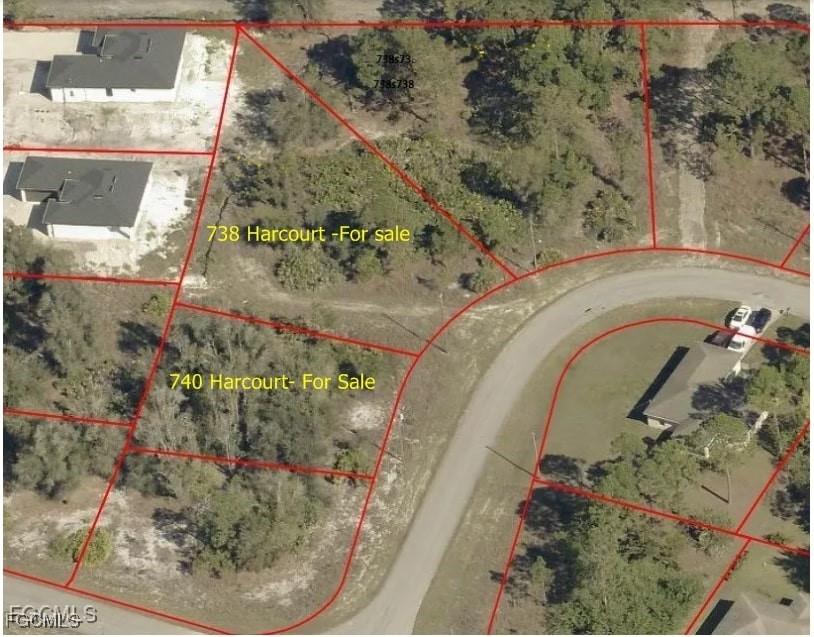 740 Harcourt Avenue Lehigh Acres, FL 33974 - Photo 4 of 7 an aerial view of a garden