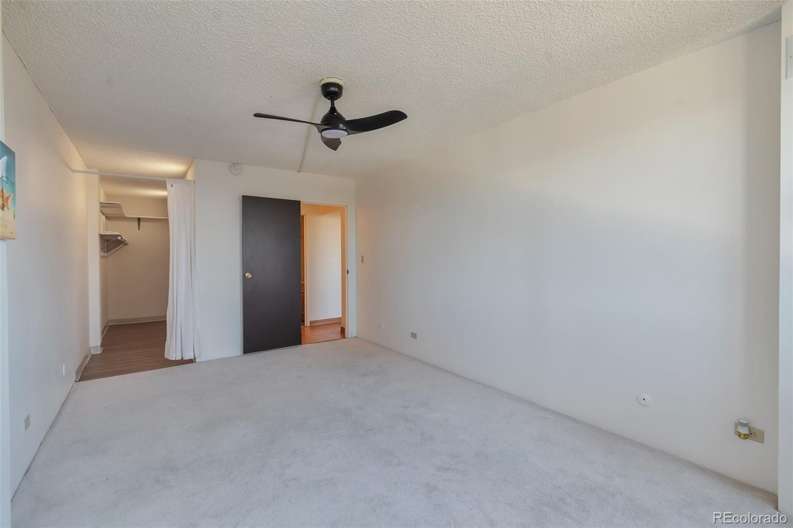 1850 Folsom Street, Unit 411 Boulder, CO 80302 - Photo 12 of 28 a view of a big room with closet and chandelier fan