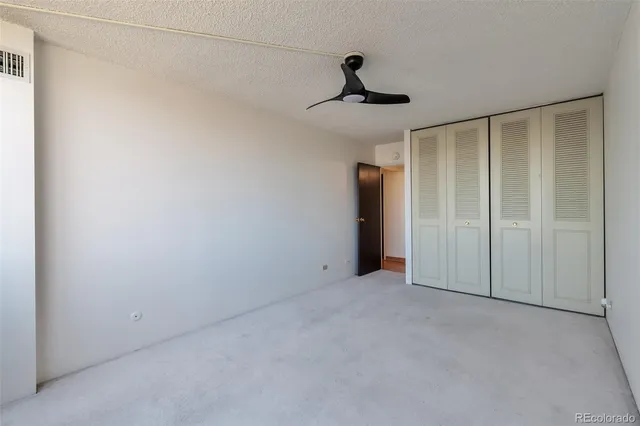 a view of an empty room with a chandelier