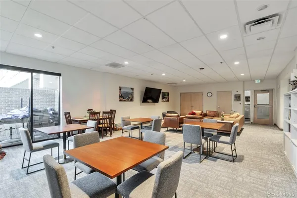 a living room with furniture a table and chairs