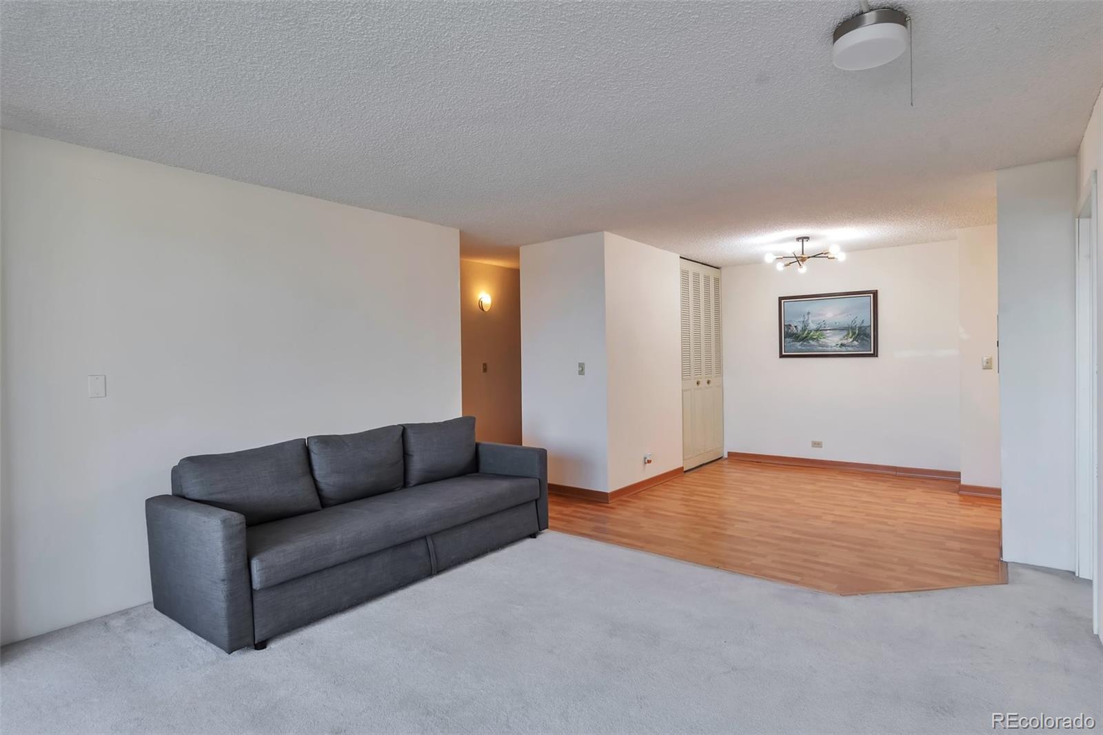 1850 Folsom Street, Unit 411 Boulder, CO 80302 - Photo 5 of 28 a living room with furniture and a flat screen tv